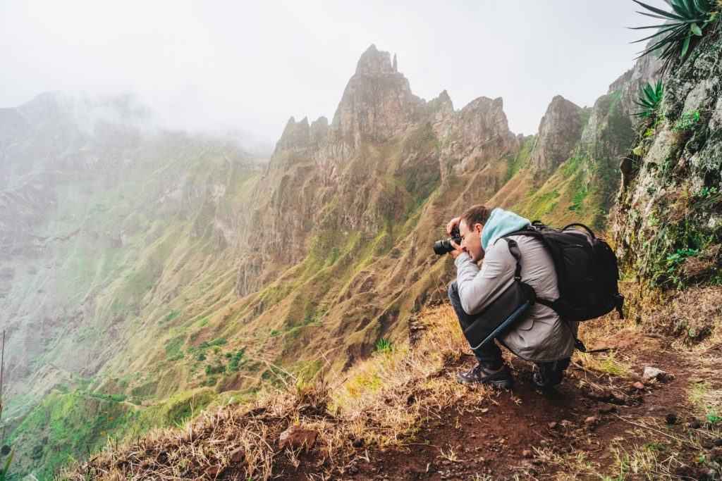 Santo Antao Island, Cape Verde. Hiking outdoor activity. Male traveler photographing mountain peaks in surreal Xo Xo valley